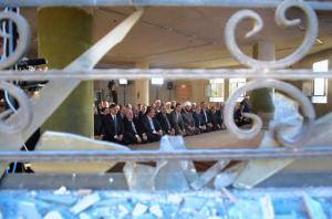 In this photo released on the official Facebook page of the Syrian Presidency, Syrian President Bashar Assad, fifth left, prays at the dawn Eid al-Adha prayers at the Saad ibn Muaaz Mosque in Daraya, a blockaded Damascus suburb, Syria, Monday, Sept. 12, 2016. (Syrian Presidency via Facebook)