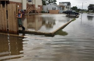 Chloe Riffle, 7, watches as she is surrounded by water on Sunday, Sept. 4, 2016 in the Ocean View section of Norfolk, Va. Storm system Hermine spun away from the U.S. East Coast on Sunday, removing the threat of heavy rain but maintaining enough power to churn dangerous waves and currents and keep beaches off-limits to disappointed swimmers and surfers during the holiday weekend. (Vicki Cronis-Nohe /The Virginian-Pilot via AP)