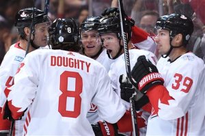 Team Canada's Corey Perry, second right, celebrates his goal with teammates Jay Bouwmeester, from left, Drew Doughty, Jonathan Toews and Logan Couture during first period World Cup of Hockey action against Team USA in Toronto on Tuesday, Sept. 20, 2016. (Frank Gunn/The Canadian Press via AP)