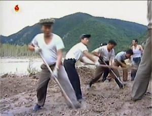 In this undated image from video distributed on Monday, Sept. 12, 2016, by North Korean broadcaster KRT, North Korean workers build levees along a river bank. North Korea is mobilizing to deal with a disastrous flood that killed more than 130 people, destroyed tens of thousands of homes and crippled infrastructure in its northern-most province. (KRT via AP)