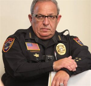 In this Oct. 20, 2015 photo, Bay St. Louis Chief of Police Michael DeNardo listens during a city council meeting in Bay St. Louis, Miss. Hancock County Coroner Jim Faulk said Chief  DeNardo died Thursday, Sept. 8, 2016. (John Fitzhugh/The Sun Herald via AP)