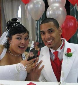 This undated photo provided by the U.S. Marshals shows Jihad Amir Ramadan, who is charged with murder, as he poses with an unknown woman at what Marshals believe is their wedding. Agents want to speak to the woman, although she's not suspected of any wrongdoing. Ramadan, who was born Justin Faustin, is accused of stabbing a fellow student at Hampton University in Virginia in 2005 and has been on the run ever since. (U.S. Marshals via AP)
