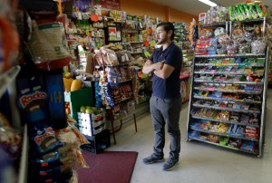 Alex Del Rio stands in the doorway while posing for photos at his family's market El Ahorro in San Francisco, Wednesday, Sept. 21, 2016. In November 2016, voters in San Francisco and Oakland will consider a penny per ounce tax on sugar laden drinks such as bottled cola, sports drinks and iced teas in November. (AP Photo/Jeff Chiu)