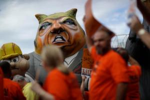 Laborers' International Union of North America members and Culinary Union members walk by an inflatable figure depicting Republican presidential nominee Donald Trump during a protest outside of the Trump International hotel, Wednesday, Sept. 21, 2016, in Las Vegas. The unions were protesting what they say is an anti-union stance by the hotel. (AP Photo/John Locher)