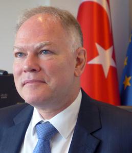 Turkey's Ambassador to the European Union Selim Yenel pauses before speaking during an interview at the Turkish embassy in Brussels on Thursday, Aug. 11, 2016. Yenel said on Thursday that Ankara could be willing to modify its anti-terror law if the changes do not impede the fight against terrorism and if Turkish citizens are guaranteed visa free travel in Europe in coming months. (AP Photo/Lorne Cook)