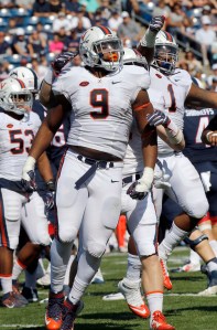 Virginia's Andrew Brown (9) and Donte Wilkins (1) celebrate a sack of Connecticut quarterback Bryant Shirreffs in the first half of an NCAA college football game Saturday, Sept. 17, 2016, in East Hartford, Conn. (AP Photo/Bill Sikes)