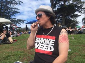 File - In this April 20, 2016, file photo, Shane Kinoshita from San Francisco smokes marijuana in Golden Gate Park in the area unofficially known as "Hippy Hill" in San Francisco. From California, with its counterculture heritage, to the fishing ports and mill towns of Maine, millions of Americans in nine states have a chance to vote Nov. 8, 2016, on expanding legal access to marijuana. Collectively, the ballot measures amount to the closest the U.S. has come to a national referendum on the drug. (AP Photo/Haven Daley, File)
