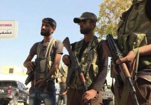 FILE - In this file image made from video posted online on Sunday, Oct. 16, 2016 by Qasioun News Agency, Turkish-backed Syrian opposition forces patrol in Dabiq, Syria. Turkish-backed Syrian opposition forces have captured the symbolically significant town of Dabiq from the Islamic State group, the factions said Sunday morning. Simultaneous attacks on the Islamic State-held city of Mosul in Iraq and Raqqa, the de facto IS capital across the border in eastern Syria, would make military sense: They would make it harder for the extremists to move reinforcements and deny them a safe haven. (Qasioun News Agency via AP, File)