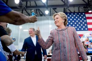 Democratic presidential candidate Hillary Clinton, right, accompanied by former Vice President Al Gore, left arrives for a rally at Miami Dade College in Miami, Tuesday, Oct. 11, 2016. (AP Photo/Andrew Harnik)