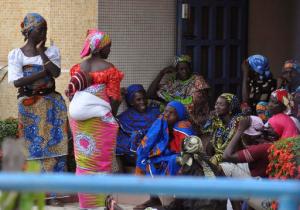 Family members of the Nigerian Chibok kidnapped girls await their departure to meet the Nigerian minister of women affairs in Abuja, Nigeria, Tuesday, Oct. 18, 2016. Nigeria's government is negotiating the release of another 83 of the Chibok schoolgirls taken in a mass abduction two-and-a-half years ago, but more than 100 others appear unwilling to leave their Boko Haram Islamic extremist captors, a community leader said Tuesday.(AP Photo/Olamikan Gbemiga)