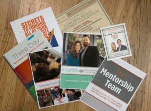 This Monday, Sept. 19, 2016, photo shows some of the literature Susan Martin has received about events on how to flip homes, on display at her Chico, Calif., home. Martin and others say they attend the live events to learn about flipping homes from reality stars like the Meredith's or Tarek and Christina El Moussa, of HGTV's "Flip or Flop," only to find that the stars don't appear and they are asked to spend thousands of dollars to attend more classes. (AP Photo/Rich Pedroncelli)