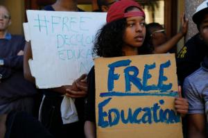 Students from the University of Cape Town, UCT, protest on their campus demonstrating for free education  in Cape Town, South Africa, Monday, Oct. 3,  2016. A South African Education Minister Blade Nzimande said Monday a small minority of university students is trying to spread “anarchy” with violent protests calling for free education. (AP Photo/Schalk van Zuydam)