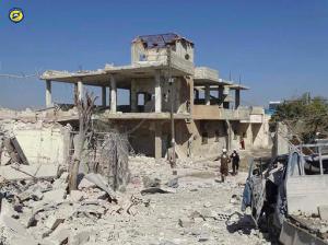 In this photo provided by the Syrian Civil Defense group known as the White Helmets, Syrian Civil Defense workers run through the damaged buildings after airstrikes in the village of Hass in the Idlib province, Syria, Wednesday, Oct. 26, 2016. Syrian activists say that airstrikes outside a school in the northern, rebel-held province of Idlib have killed more than a dozen people, mostly children. The Idlib News network says the airstrikes hit as the children gathered outside a school complex in the village of Hass. (Syrian Civil Defense White Helmets via AP)