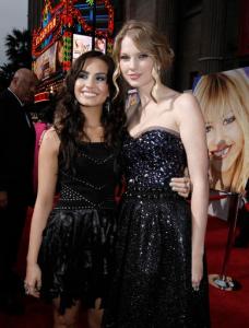 FILE - In this April 2, 2009, file photo, Taylor Swift, right, and Demi Lovato pose together at the premiere of "Hannah Montana the Movie" in Los Angeles. Lovato announced on Twitter Tuesday, Oct. 4, 2016, that she's “taking a break from music and the spotlight” in the wake of criticism of her comments about Taylor Swift in a magazine interview. (AP Photo/Matt Sayles, File)