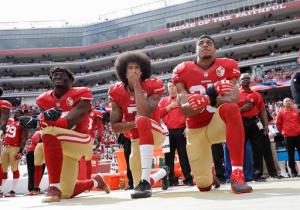 FILE - In this Oct. 2, 2016 file photo, from left, San Francisco 49ers outside linebacker Eli Harold, quarterback Colin Kaepernick and safety Eric Reid kneel during the national anthem before an NFL football game against the Dallas Cowboys in Santa Clara, Calif. A new poll shows that most white Americans disapprove of athletes protesting during the playing of “The Star-Spangled Banner.”  (AP Photo/Marcio Jose Sanchez, File)