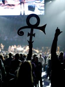 A Prince fan holds up his symbol Thursday, Oct. 13, 2016 in St. Paul, Minn., during a tribute concert honoring the late musician who died in April (AP Photo/Jim Mone)