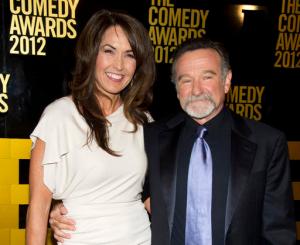 FILE - In this April 28, 2013 file photo, Robin Williams, right, and his wife Susan Schneider Williams arrive to The 2012 Comedy Awards in New York. Schneider wrote an essay published in the medical journal, "Neurology," on Sept. 27, 2016, that Williams had "chemical warfare in his brain” before his death. (AP Photo/Charles Sykes, File)