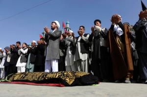 Afghans pray during the funeral of victim who died, a militant attack at a Shiite shrine in Kabul, Afghanistan, Wednesday, Oct. 12, 2016. An Afghan official say several people including a policeman were killed after a militant attack on a Shiite shrine in the capital Kabul late Tuesday. Sediq Sediqqi, the interior ministry's spokesman said Wednesday that another 62 people, including 12 policemen were wounded in the attack. (AP Photos/Rahmat Gul)