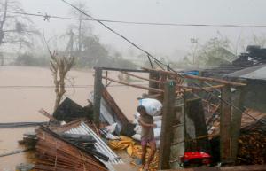 A resident carries a sack of rice after Super Typhoon Haima destroyed his home and caused flooding at Vigan township, Ilocos Sur province in northern Philippines Thursday, Oct. 20, 2016. Super Typhoon Haima slammed into the northeastern Philippine coast late Wednesday with ferocious winds and rain that rekindled fears and memories from the catastrophe wrought by Typhoon Haiyan in 2013. (AP Photo/Bullit Marquez)