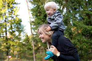 In this photo taken Tuesday, Sept. 20, 2016, Emelie Eriksson carries her son Albin outside her home in Bergshamra, Sweden. Eriksson was the first woman to have a baby after receiving a womb transplant from her mother, a revolutionary operation that links three generations of their family. (AP Photo/ Niklas Larsson)