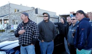 Norfolk Southern employees wait down the road to be let into work, as the company placed a hold on entering the railyard, after the shooting at FreightCar America  Tuesday morning, Oct. 25, 2016. Police say a man fatally shot someone and wounded several others inside FreightCar America, a rail car manufacturing company, before apparently killing himself. (Heather Rousseau/The Roanoke Times via AP)