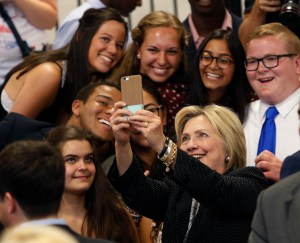 FILE - In this June 21, 2016 file photo, Democratic presidential candidate Hillary Clinton takes a photo with supporters after speaking at Fort Hayes Vocational School in Columbus, Ohio. A new poll finds that young voters are starting to come through for Clinton, particularly among whites ages 18 to 30. In the final days of the campaign, Clinton is shored up what was once a troubling weakness in a key voting bloc, a sign of strength that helps explain how the former secretary of state may be able to expand her campaign into traditionally Republican states. (AP Photo/Jay LaPrete, File)