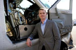 Dan Patt, Program Manager, Tactical Technology Office, Aurora Flight Sciences, stands next to the firms Aircrew Labor In-Cockpit Automantion System (ALIAS), which is mounted in the co-pilot seat of a Cessena Caravan aircraft, at Manassas Airport in Manassas, Va., Monday, Oct. 17, 2016. Government and industry are working together on a robot-like autopilot system that could eliminate the need for a second human pilot in the cockpit. (AP Photo/Cliff Owen)