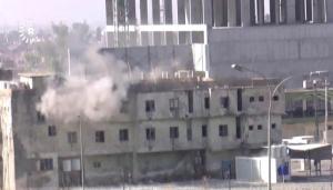 In this image made from video, smoke rises from a building where two militants are believed to be holed up, according to Rudaw TV, in Kirkuk, Iraq, Friday, Oct. 21, 2016. Militants armed with assault rifles and explosives attacked targets in and around the northern Iraqi city of Kirkuk early on Friday in an assault quickly claimed by the Islamic State group and likely aimed at diverting authorities' attention for the battle to retake IS-held Mosul. (Rudaw TV via AP)