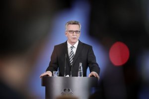 German Interior Minister Thomas de Maiziere speaks during a press statement on the determined total number of applicants for asylum in Berlin, Germany, Friday, Sept. 30, 2016. Germany says a total of 820,000 asylum seekers entered the country last year, but that the count this year so far is dramatically down. (Michael Kappeler/dpa via AP)