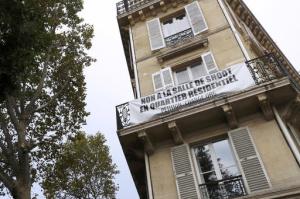 A bannner reading "No to a injection site in residential area" is pictured near first safe- injection room for drug addicts in Paris, Tuesday, Oct. 11, 2016. France opens its first safe-injection room for drug addicts despite years of efforts by conservatives to block the plan. Intravenous drug users will be given access to clean needles under medical supervision and in the presence of drug counselors in an effort to prevent viral infections and overdoses. (Patrick Kovarik, Pool via AP)