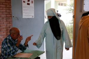 A woman casts her ballot at a polling station for the parliamentary elections, in  Rabat, Morocco, Friday, Oct. 7, 2016. Millions of Moroccans hit the voting booths, with worries about joblessness and extremism on many minds as they choose which party will lead their next government.(AP Photo/Abdeljalil Bounhar)