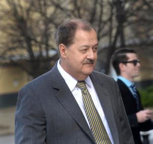 FILE - In a Wednesday, April 6, 2016 file photo, former Massey CEO Don Blankenship is escorted by Homeland Security officers from the Robert C. Byrd U.S. Courthouse in Charleston, W.Va. Blankenship, who was sentenced to a year in jail and a $250,000 fine for his role in the Upper Big Branch Mine explosion,  has declared himself an “American political prisoner” on his blog, blaming others for the 2010 mine explosion that killed 29 men and led to the former West Virginia coal operator’s imprisonment. The ex-Massey Energy CEO said he plans to distribute 250,000 copies of the 67-page diatribe in booklet form.  (F. Brian Ferguson/Charleston Gazette-Mail via AP, File)
