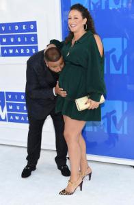 FILE - In this Sunday, Aug. 28, 2016, file photo, DJ Khaled, left, and Nicole Tuck arrive at the MTV Video Music Awards at Madison Square Garden in New York. DJ Khaled and his fiancee Nicole Tuck welcomed their first child, a boy, into the world early Sunday, Oct. 23, 2016. Khaled chronicled the birth in a series of snapchats showing inside the delivery room where he can be heard telling the doctor that “it’s go time.” (Photo by Evan Agostini/Invision/AP, File)