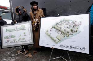 File - In this Sunday, Feb. 17, 2013, file photo Diane Gomes, of Johnston, R.I., left, and Elaine Grant, of Lincoln, R.I., center, display artist's renderings of a planned permanent memorial for victims of The Station nightclub fire, a blaze that claimed the lives of 100 people, during ceremonies at the site of the fire, in West Warwick, R.I. Organizers of the effort to build a permanent memorial at the site of the February 2003 blaze at the Station nightclub in Rhode Island announced Monday, Oct. 17, 2016, that they have achieved their $2 million fundraising goal. (AP Photo/Steven Senne, File)