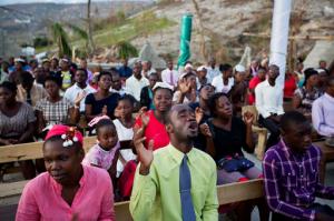 Residents pray at a church that was destroyed by hurricane Matthew in Jeremie, Haiti. Sunday, Oct. 9, 2016. An international response is finally getting underway as Haitian authorities try to gauge the full extent of the staggering blow delivered by Hurricane Matthew, including hundreds dead and tens of thousands of homes obliterated. (AP Photo/Dieu Nalio Chery)