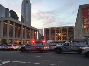 Police respond to New York's Metropolitan Opera which halted a performance after someone sprinkled an unknown powder into the orchestra pit, Saturday, Oct. 29, 2016. Met spokesman Sam Neuman said the afternoon's performance of "Guillaume Tell" was canceled during the second intermission after the person sprinkled the powder into the pit from the orchestra section. A police spokeswoman said the person who sprinkled the powder fled and was being sought. (Dylan Hayden via AP)