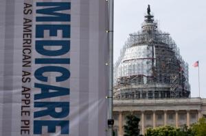 FILE - In this July 30, 2015 file photo, a sign supporting Medicare is seen on Capitol Hill in Washington. Medicare on Friday, Oct. 14, 2016, unveiled a far-reaching overhaul of how it pays doctors and other clinicians. Compensation for medical professionals will start taking into account the quality of service, not just quantity. (AP Photo/Jacquelyn Martin, File)