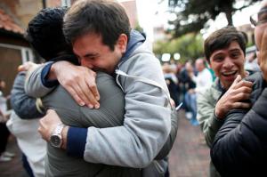 Opponents to the peace deal signed between the Colombian government and rebels of the Revolutionary Armed Forces of Colombia, FARC, celebrate as they listen to the results of the referendum to decide whether or not to support a peace accord to in Bogota, Colombia, Sunday, Oct. 2, 2016. A referendum on Colombia's peace deal with leftist rebels was going far worse than expected for the government Sunday, with those favoring the deal leading by a razor-thin margin with more than half the votes counted.  (AP Photo/Ariana Cubillos)