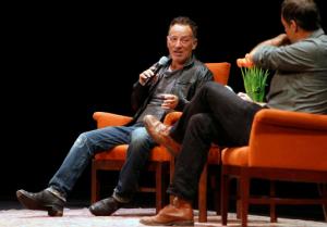 In this photo taken Wednesday, Oct. 6, 2016, musician Bruce Springsteen talks about his book "Born to Run" with Dan Stone, right, during an event at the Nourse Theater in San Francisco. Springsteen credits his music with helping him navigate depression, and says playing marathon shows until he was exhausted helped chase away the blues. Springsteen spoke to an adoring, sold-out crowd on Wednesday night, in a 1-hour, 20-minute on-stage interview as part of a nationwide tour for his best-selling new autobiography. (Scott Strazzante/San Francisco Chronicle via AP)