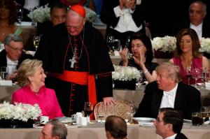 Republican presidential candidate Donald Trump, right, talks with Democratic presidential candidate Hillary Clinton, left, and Cardinal Timothy Dolan, Archbishop of New York, during the Alfred E. Smith Memorial Foundation dinner, Thursday, Oct. 20, 2016, in New York. (AP Photo/ Evan Vucci)