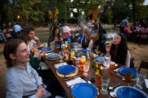 In this Oct. 2, 2016 photo, diners smoke marijuana as they eat dishes prepared by chefs during an evening of pairings of fine food and craft marijuana strains served to invited guests dining at Planet Bluegrass, an outdoor venue in Lyons, Colo. Chefs and pot growers trying to explore fine dining with weed face a legal gauntlet to make pot dinners a reality, even where the drug is legal. (AP Photo/Brennan Linsley)