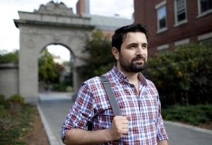 In this Thursday, Oct. 13, 2016 photo, Khaled Almilaji, who coordinated a campaign that vaccinated 1.4 million Syrian children and risked his life to provide medical care during the country's civil war, stands for a portrait on the campus of Brown University in Providence, R.I. Almilaji is now in the Ivy League, learning about how to rebuild Syria's health system when the war finally ends. (AP Photo/Steven Senne)