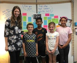 In this photo provided by Kate Baker, taken Oct. 19, 2016, Fourth grade teacher Halie Miller and students at Glacier Ridge Elementary School in Dublin, Ohio are using the election as a teaching tool for her students in social studies and math. From left are, Halie Miller, Calvin McCormick, Sriram Katta, Audrey DiCesare and Mia Dahi. (Kate Baker via AP)