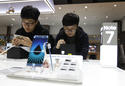 FILE - In this Monday, Oct. 10, 2016, file photo, South Korean high school students try out Samsung Electronics Galaxy Note 7 smartphones at the company's shop in Seoul in Seoul, South Korea. Samsung is asking owners of its fire-prone Galaxy Note 7 to do something crazy: “power down and stop using the device.” This is all but unthinkable in an age where smartphones have become an extra limb, the last thing we look at before falling asleep and the first thing we grab in the morning, not to mention throughout the day. (AP Photo/Ahn Young-joon, File)