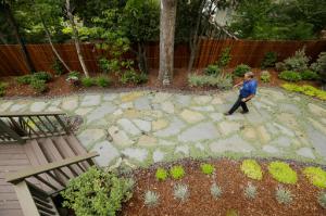 In this photo taken Tuesday, Aug. 23, 2016, city water resources specialist Randy Barron walks through a low water use garden in the backyard of a Lomita Heights home in Santa Rosa, Calif. California water agencies that spent more than $350 million in the last two years of drought to pay property owners to rip out water-slurping lawns are now trying to answer whether the nation's biggest lawn removal experiment was all worth the cost. (AP Photo/Eric Risberg)