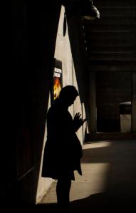 FILE - In this Wednesday, Oct. 12, 2016, file photo, moments before boarding an arriving train to Manhattan, a morning commuter uses his smartphone on the platform of the Long Island Rail Road at the Bayside Station in the Queens borough of New York. TVs are so last century. News outlets are using Facebook Live, Snapchat, YouTube and other tools to offer live coverage of Election Day in ways not possible four years ago. (AP Photo/Alexander F. Yuan, File)