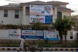 A Pakistani vendor walks past the Rawalpindi campus of Pak-Turk school in Pakistan, Wednesday, Nov. 16, 2016. akistan has ordered 400 Turk nationals associated with the Pak-Turk International chain of schools and colleges to leave the country in the next 72 hours, says a statement on the school's website. The deportation order comes as Turkish President Erdogan is to arrive in Islamabad on a two-day visit to discuss bilateral, International and regional issues with Pakistani leadership. (AP Photo/B.K. Bangash)