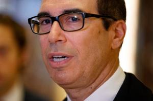 Steven Mnuchin, President-elect Donald Trump's nominee for Treasury Secretary, talks with reporters in the lobby of Trump Tower, Wednesday, Nov. 30, 2016, in New York. (AP Photo/Evan Vucci)