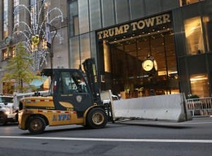 Police officers help to install concrete barriers around Trump Tower, the home of President-elect Donald Trump, in New York, Wednesday, Nov. 9, 2016. A day after Trump, against all odds, won election as America's 45th president, Hillary Clinton on Wednesday lamented that the nation proved to be "more divided than we thought" but told supporters: "We owe him an open mind and a chance to lead." (AP Photo/Seth Wenig)