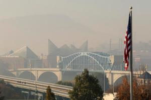 In this Wednesday, Nov. 16, 2016 photo, smoke from wildfires fill downtown Chattanooga, Tenn., and the Tennessee Valley with a pungent haze as seen from the North Shore area of Chattanooga. (Dan Henry/Chattanooga Times Free Press via AP)